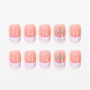 Ten pink short square French nails with pale lilac tips and silver cross accents on white