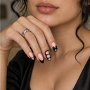 Black outline French bow and crystal almond press-on nails — worn on hand