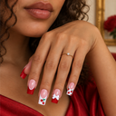Strawberry red glitter French and white bow square press-on nails — worn on hand