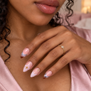 Blush French almond nails with black linework, flowers and gold accents – hand