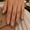 Brown French gold and pearl almond press-on nails – worn on a hand