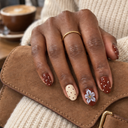 Brown cream polka dot and translucent floral oval nails – hand