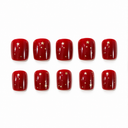 Ruby red short square nails with scattered gold stars and dots