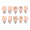 Nude almond nails with silver glitter tips, bow and heart accents