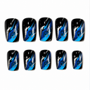 Glossy black square nails with cobalt cyan waves and silver glitter