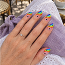 Rainbow wave starburst almond nails worn over lavender linen