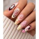 Pink cream playful nail art almond press-on nails worn on hand