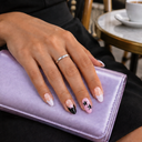 Black pink star French almond press-on nails — model wearing nail designs