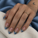 Metallic blue French and gold wave almond nails — hand
