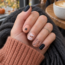 Peach mummy and spider short square nails worn with an autumn knit