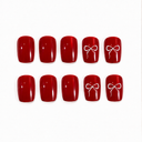 Ruby red white ribbon bow short square nails — hero