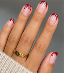 Nude red drip French square press-on nails worn on hand