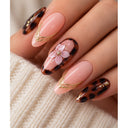 Pink tortoiseshell floral almond press-on nails worn on hand