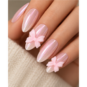 Pearlescent pink bow almond press-on nails worn on hand