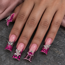 Pink animal-print duck nails with star and magenta orb charms worn on a hand against charcoal stone