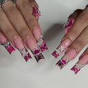 Supplier view of long pink animal-print duck nails with raised silver-tone charms