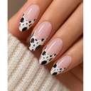 Pink cow print almond press-on nails worn on hand