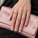 Pink floral mixed polka dot square press-on nails – worn on hand over blush clutch