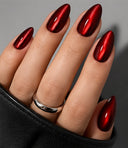 Red cat eye almond press-on nails worn on hand