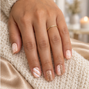 Rose gold snowflake and stripe short square nails worn against ivory knit