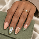 Sage green rose pearl and gold almond nails worn with a gold ring